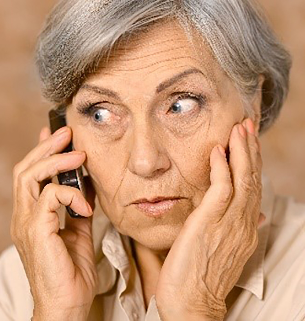 Photo of an elderly person on the telephone looking concerned.