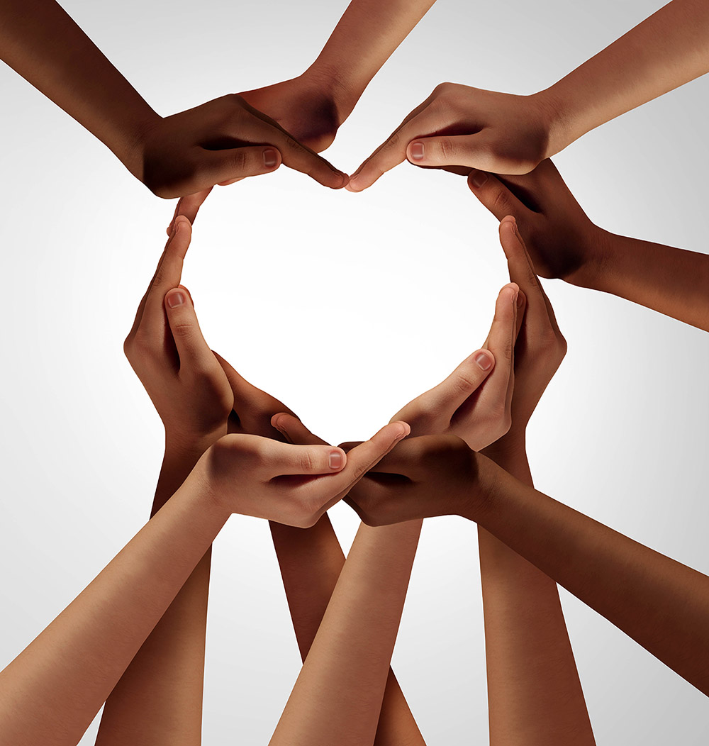 Photo of hands from many ethnicities creating a heart shape