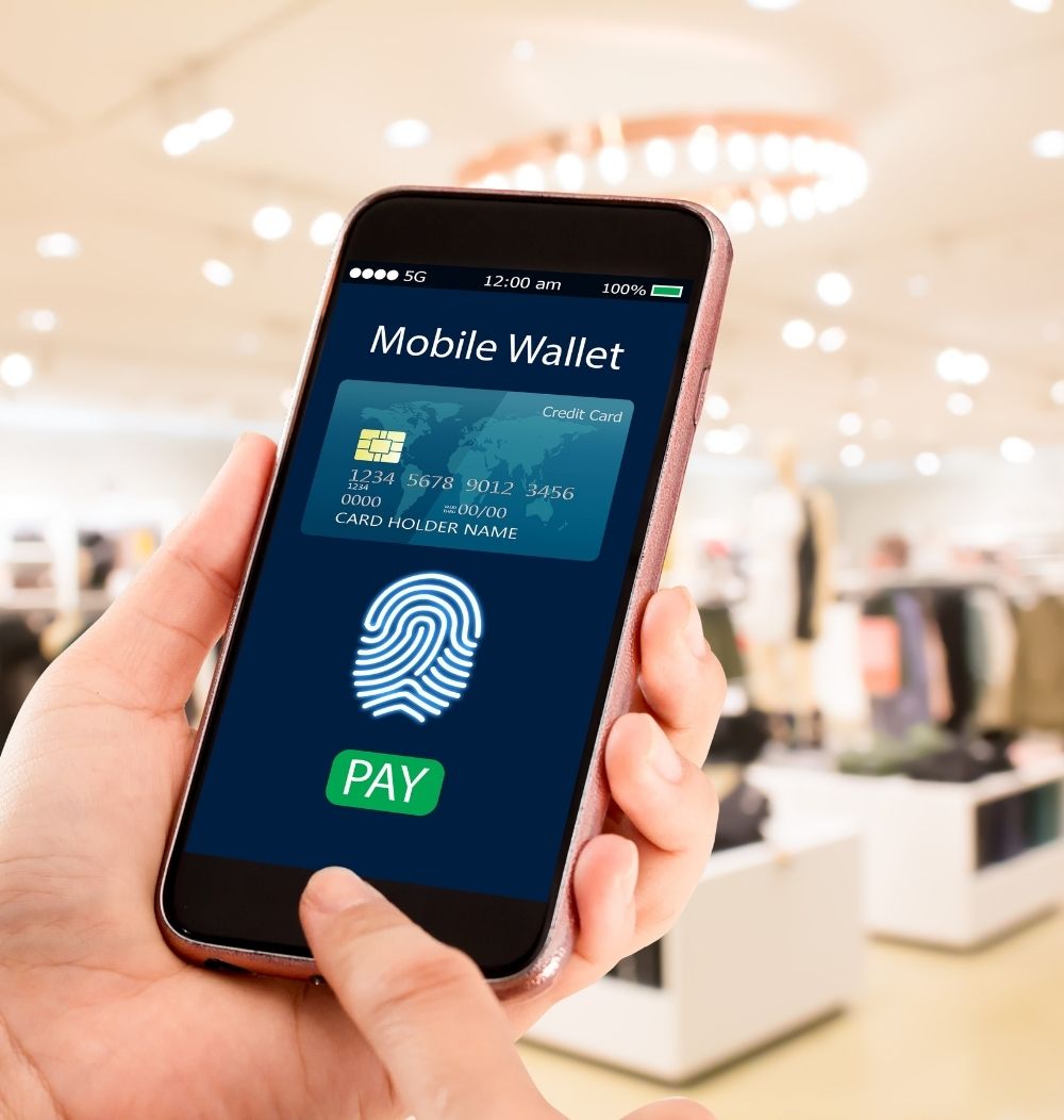 Image of someone holding a smartphone that features a screenshot of the mobile wallet app