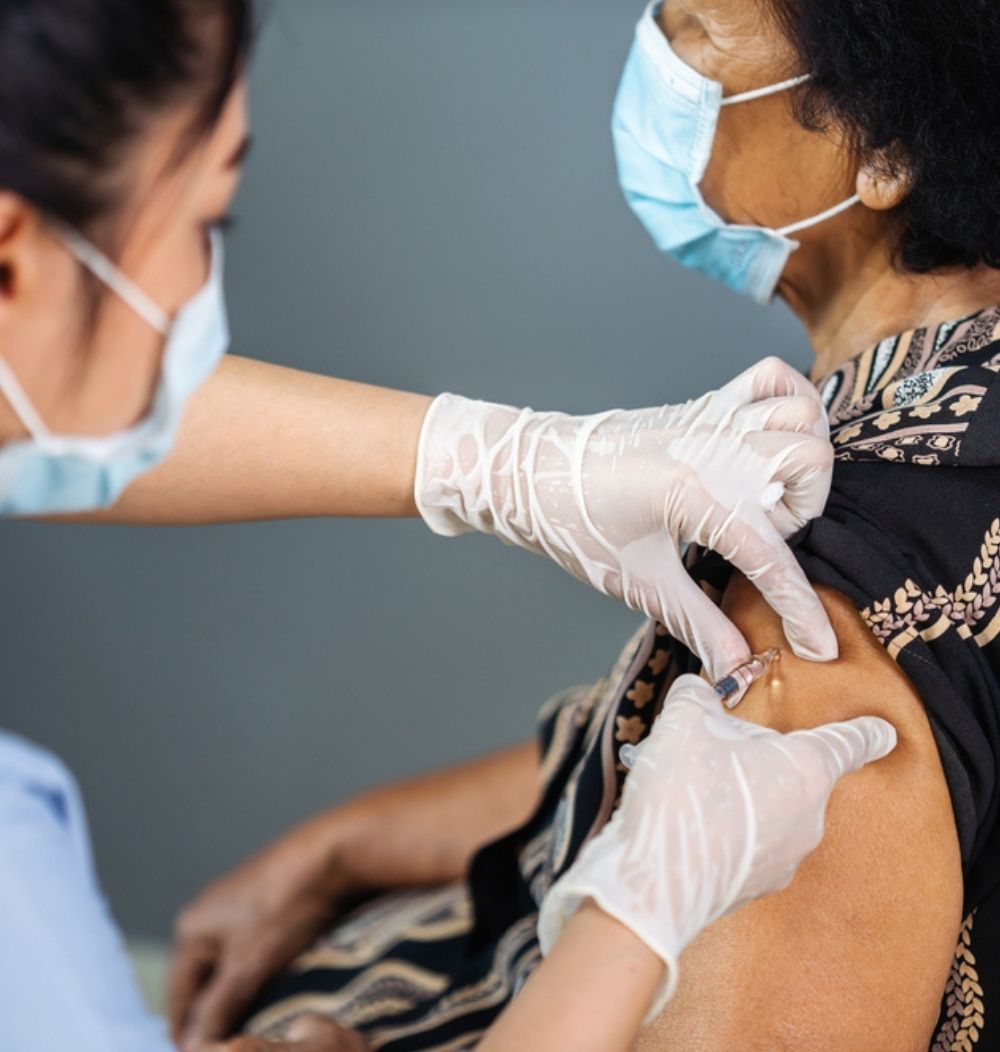 An image of a woman receiving the vaccine.