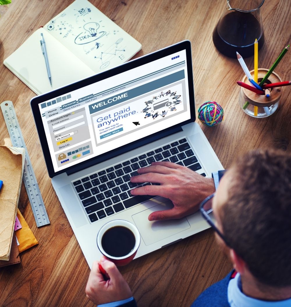 An image of a man on a computer using Business Online Banking.