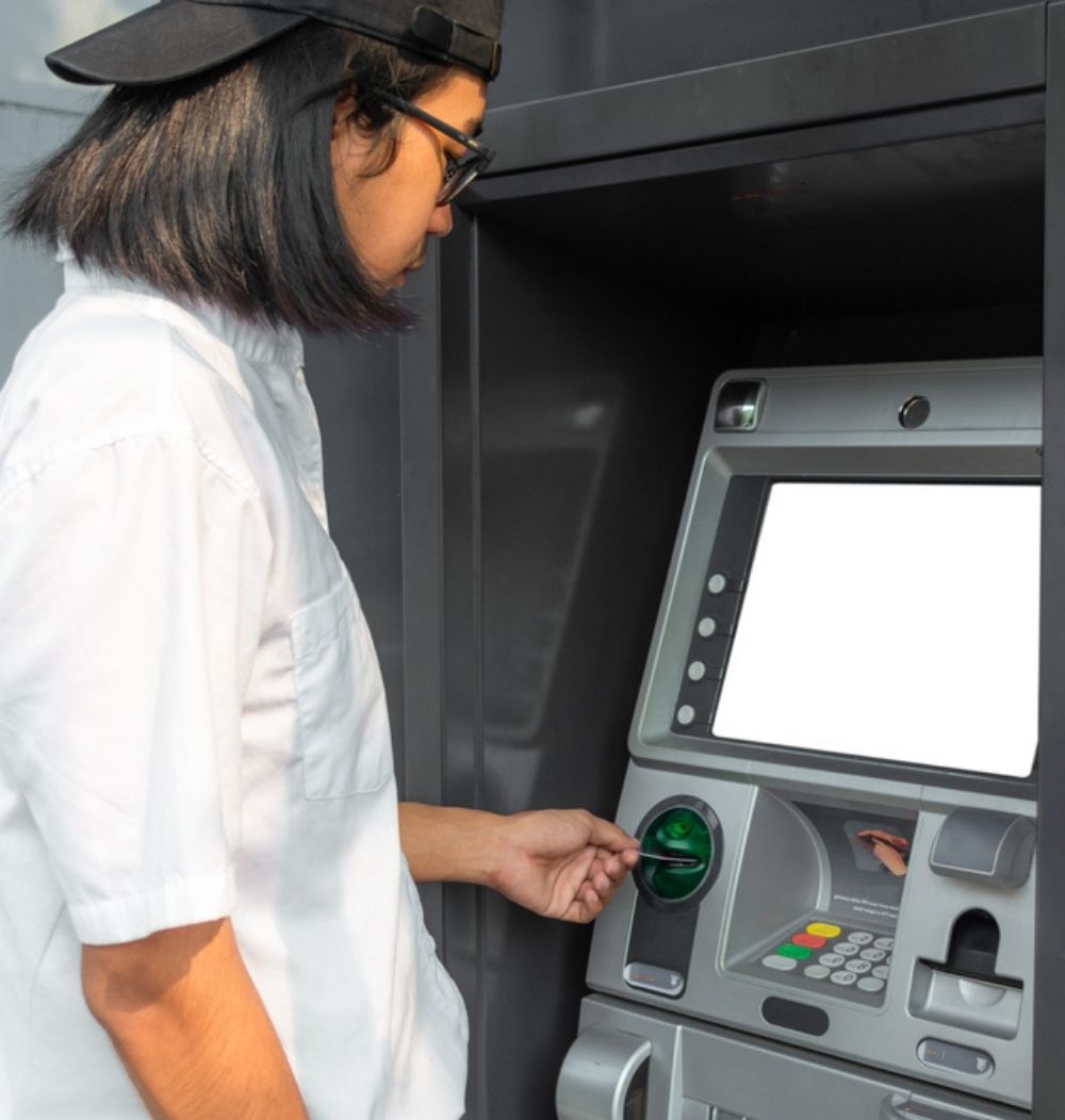 An image of a man using an ATM.
